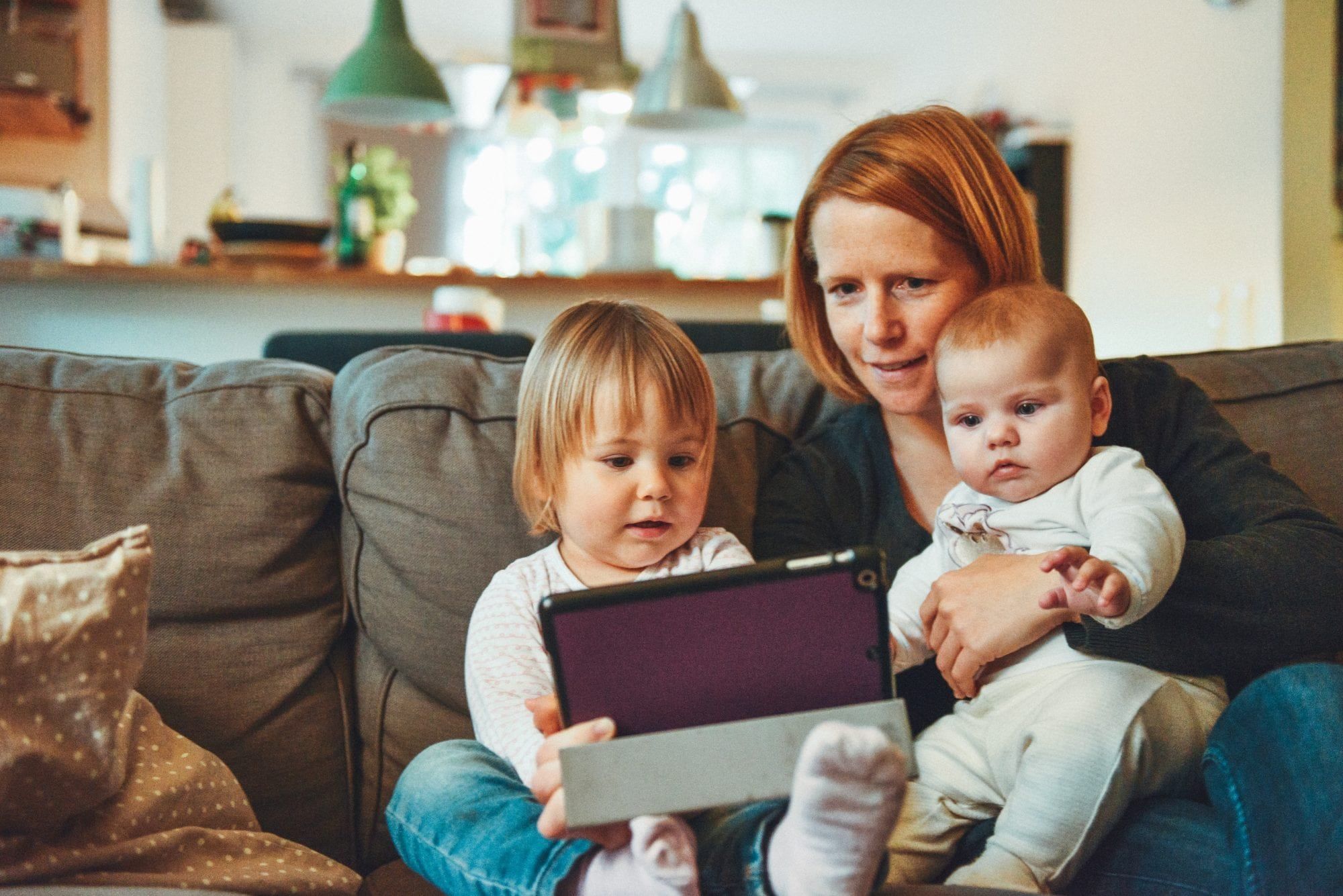 A woman planning for the future with her two young children